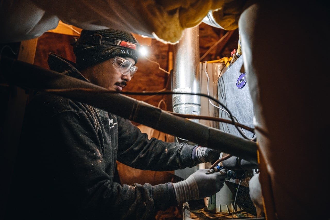 Apollo Heating and Air technician changing HVAC filter
