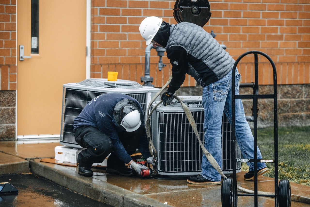 Apollo Heating and Air technicians cleaning the filter