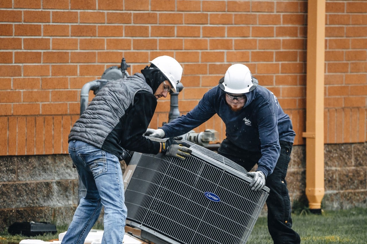 Apollo Heating and Air technicians working on HVAC