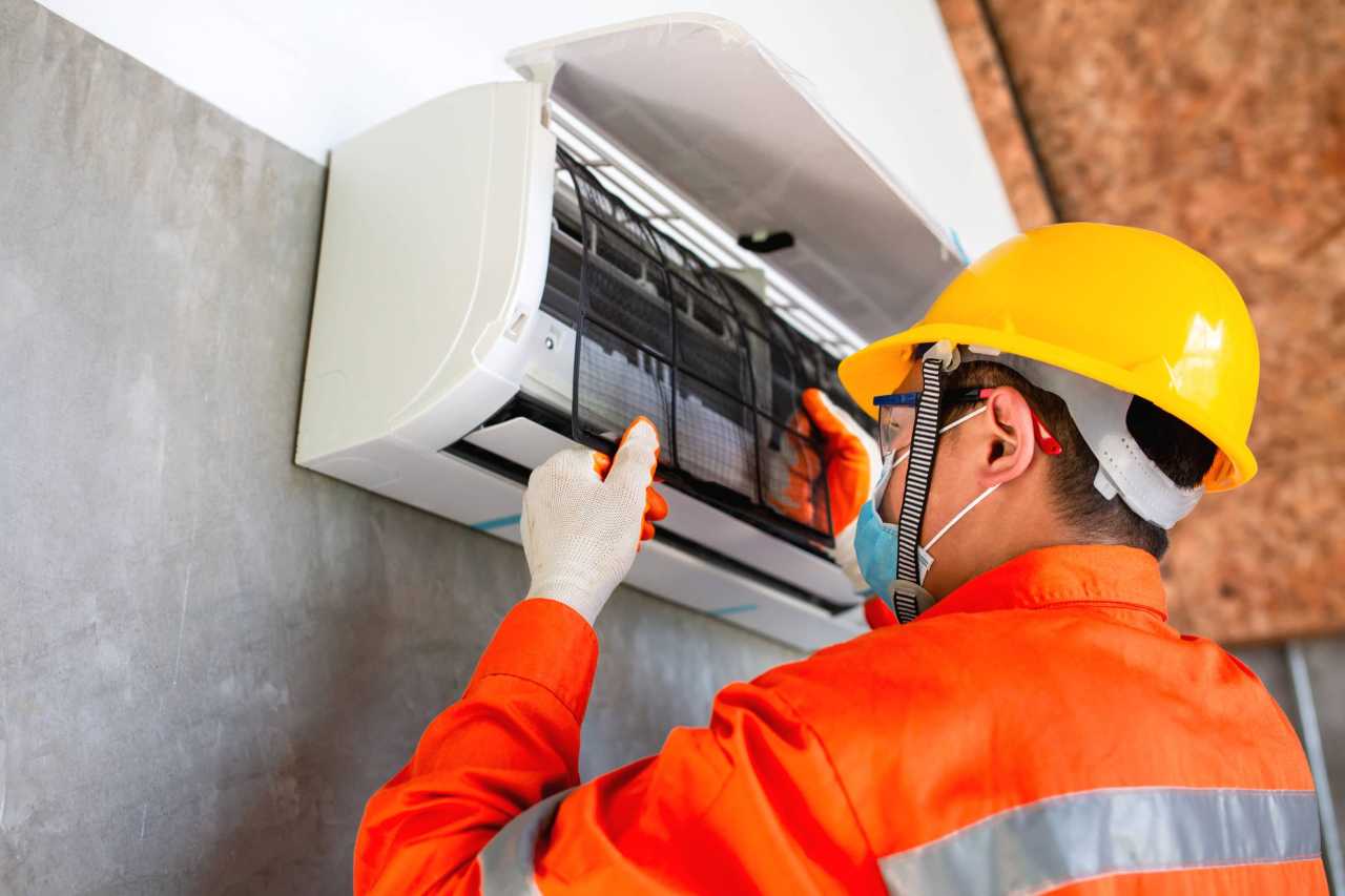 technician doing a regular AC maintenance Apollo Heating and Air