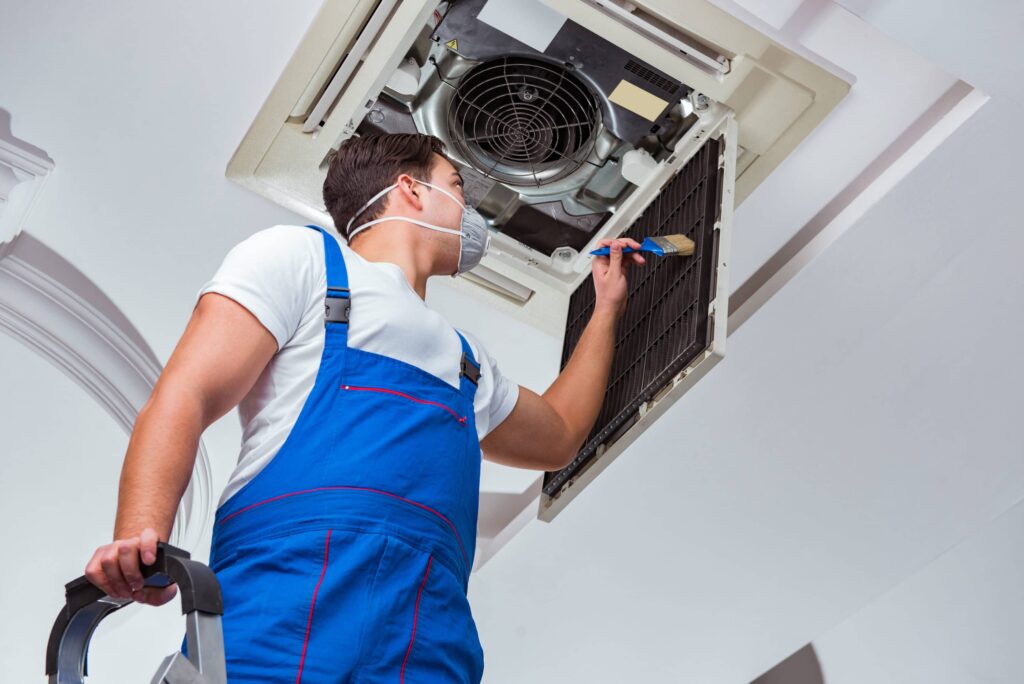 Worker conducting AC Repair to winterize your hvac