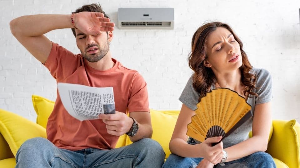 Two hot, sweaty HVAC owners struggle to keep their home cool in the 100 degree heat wave