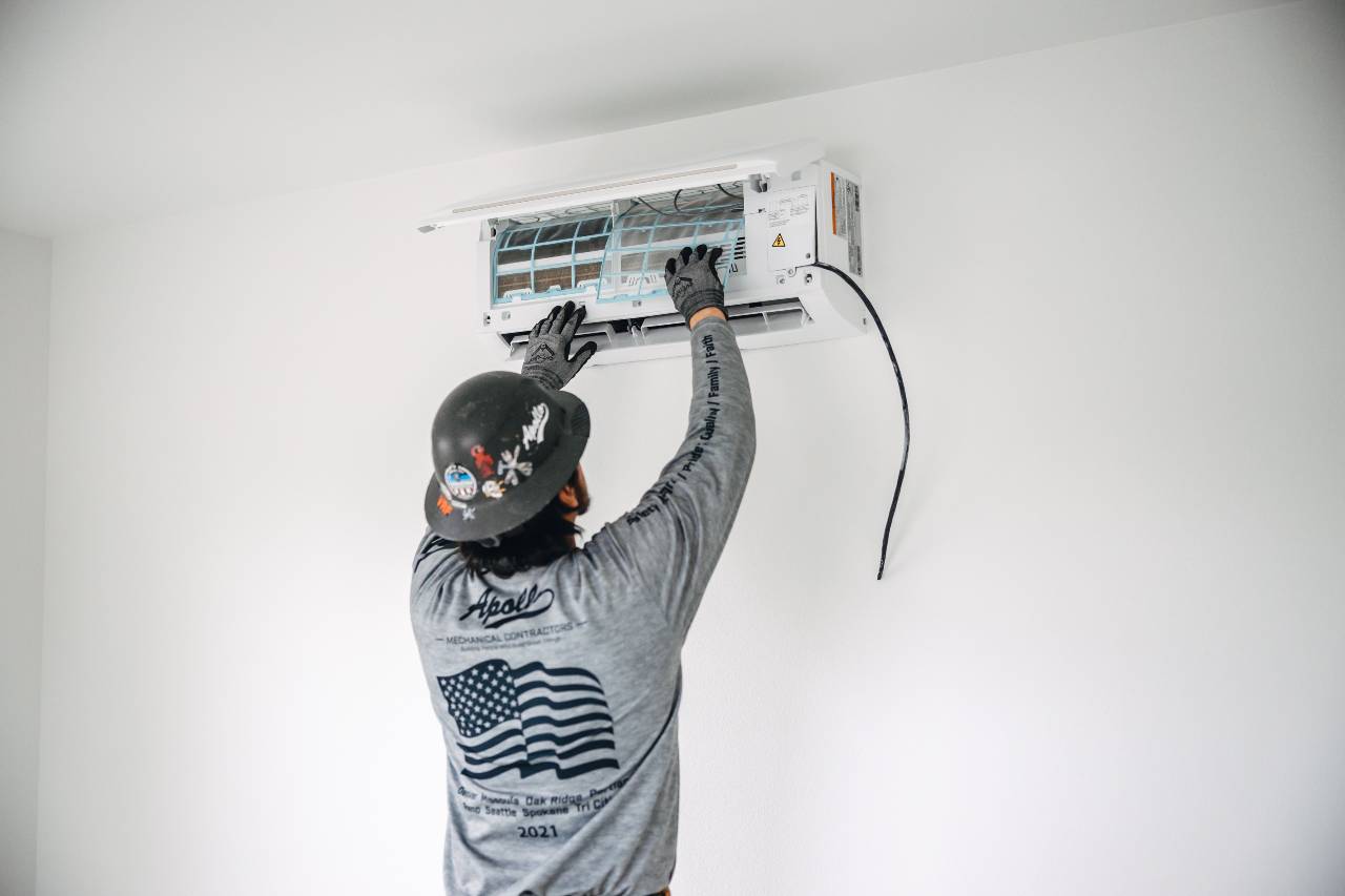 air conditioner being installed in a home by Apollo Heating & Air