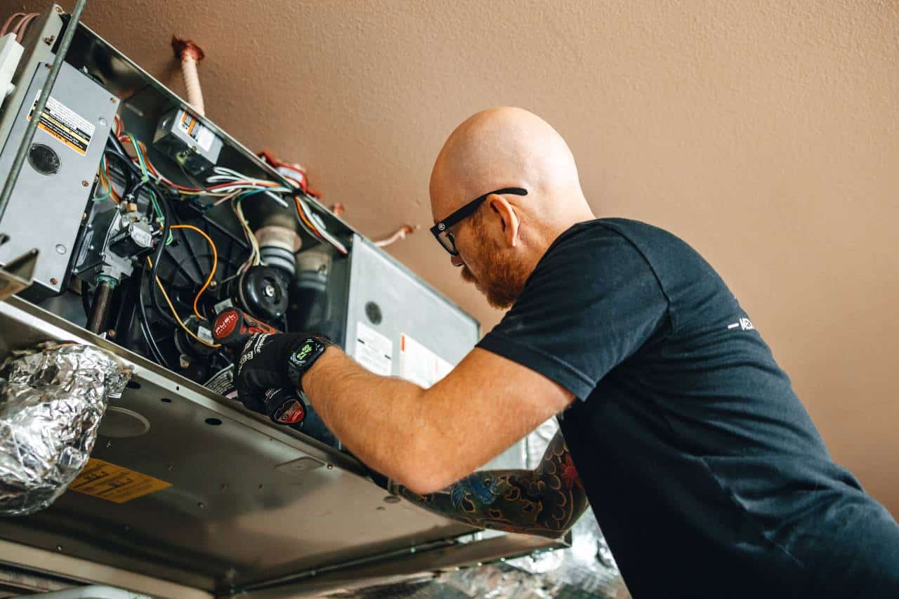 Apollo Heating & Air crew doing HVAC repair